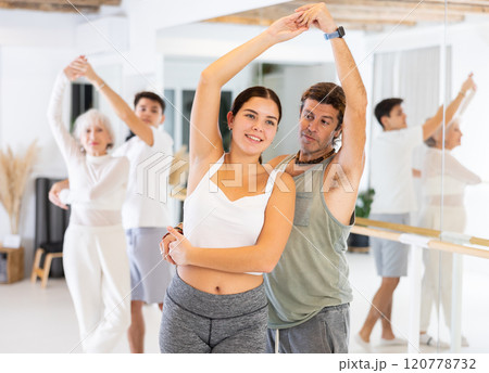 Young woman and adult man dancing as couple 120778732