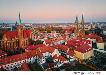 Aerial view of European city with Gothic churches and historic architecture in autumn season. St. John Cathedral on Ostrow Tumski at sunset. Cityscape panorama of Wroclaw, Poland 120779910