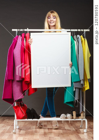 Woman in mall wardrobe with blank banner copyspace Woman in mall wardrobe with blank banner copyspace 120780591