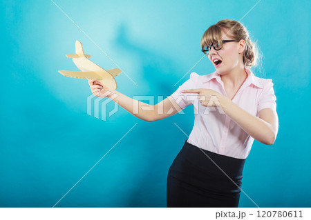 Fly fear. Woman holding airplane in hand. 120780611