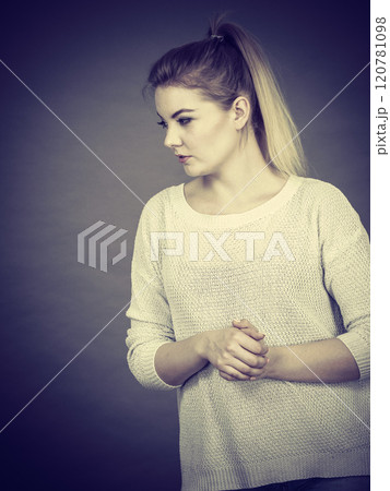 Sad woman showing thumb down gesture Sad woman showing thumb down gesture 120781098