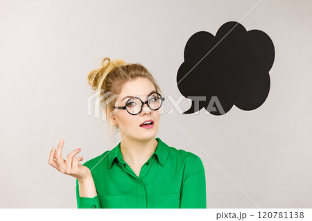 Woman holding black thinking bubble 120781138