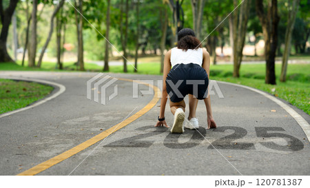 Back view of athlete woman in starting position ready for sprint. 2025 Goals and new beginning and motivation concept 120781387