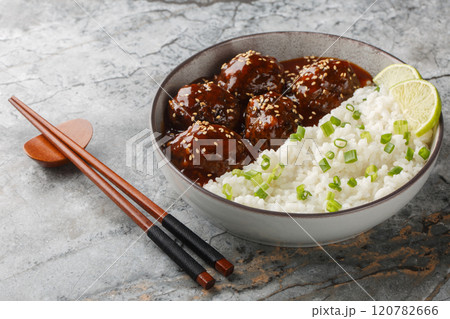 Spicy sweet chinese meatballs in honey sriracha sauce served with rice close-up in bowl. horizontal Spicy sweet chinese meatballs in honey sriracha sauce served with rice close-up in bowl. horizontal 120782666