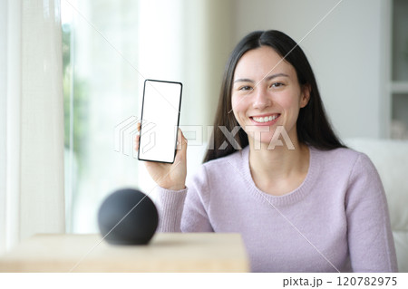 Happy asian woman with virtual speaker showing phone screen 120782975