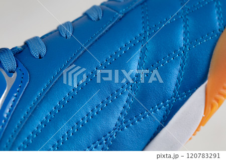 Part of a blue leather lace-up sneaker close-up. Shoe leather close-up. Part of a blue leather lace-up sneaker close-up. Shoe leather close-up. 120783291