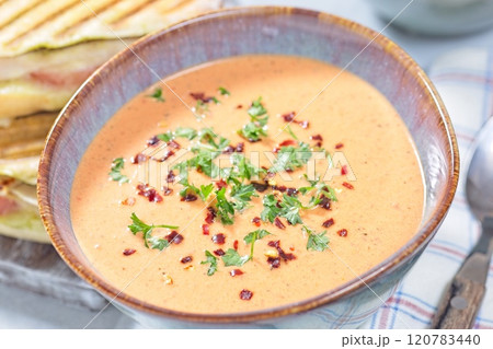 Bowl with Red bell pepper creamy soup, horizontal closeup Bowl with Red bell pepper creamy soup, horizontal closeup 120783440