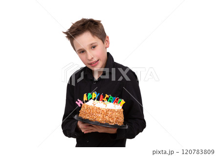 A teenage boy holds a birthday cake on a white background. A teenage boy holds a birthday cake on a white background. 120783809