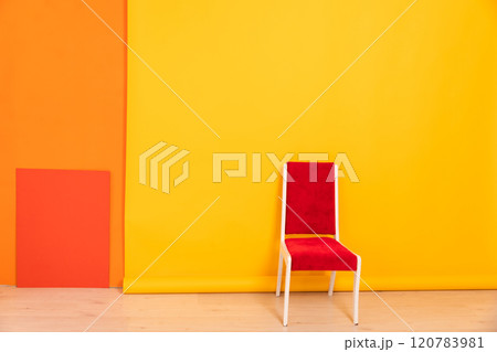 One vintage chair in the interior of a yellow orange living room 120783981