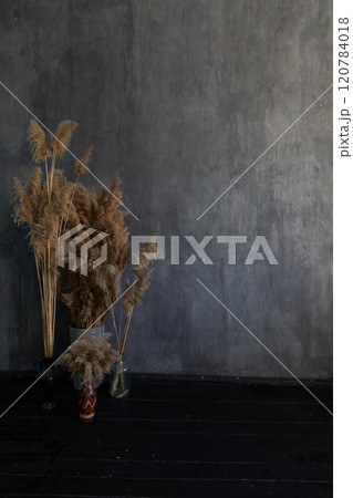 Baskets with dried flowers in a dark gray living room interior Baskets with dried flowers in a dark gray living room interior 120784018