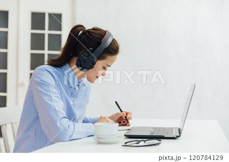 Business woman in headphones learning online 120784129