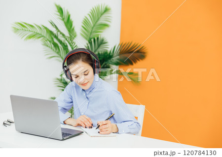 Business woman in headphones learning online Business woman in headphones learning online 120784130