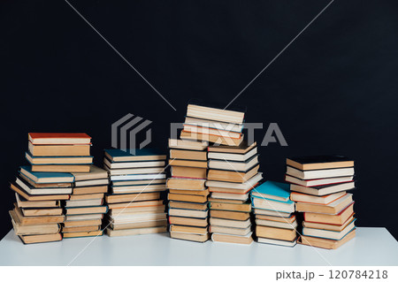Stacks of books for reading and education in college library on black background Stacks of books for reading and education in college library on black background 120784218