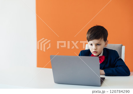 Boy In Business Suit Studying Playing On Laptop Online 120784290