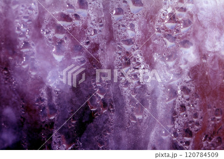 Deilcate Rain Drops of Water on Glass in a Red Pink Glow for Background Deilcate Rain Drops of Water on Glass in a Red Pink Glow for Background 120784509
