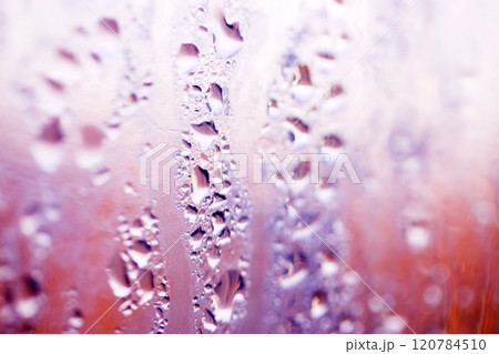 Deilcate Rain Drops of Water on Glass in a Red Pink Glow for Background Deilcate Rain Drops of Water on Glass in a Red Pink Glow for Background 120784510
