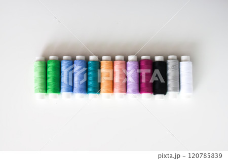Many colorful sewing threads on light background. 120785839