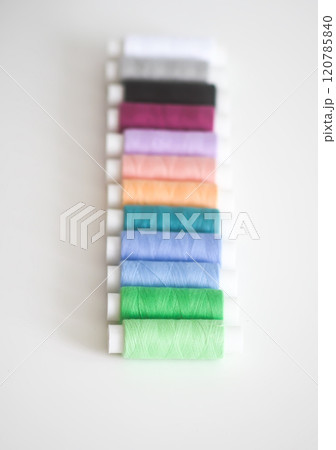 Many colorful sewing threads on light background. 120785840