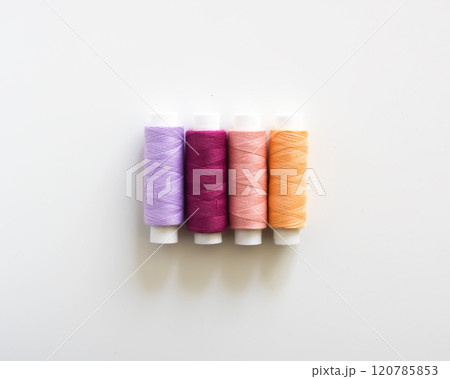 Many colorful sewing threads on light background. 120785853