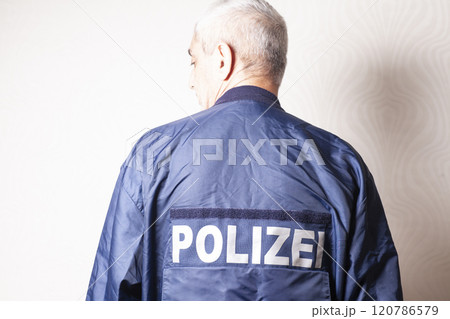 Man in a nylon jacket with the inscription in German POLICE 120786579