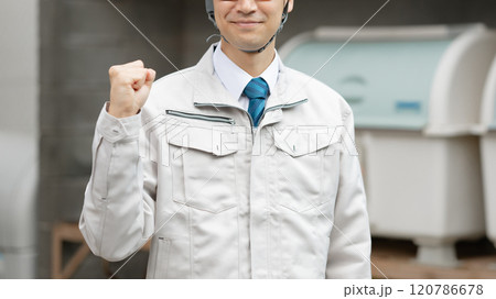 ガッツポーズをする作業服の男性 120786678