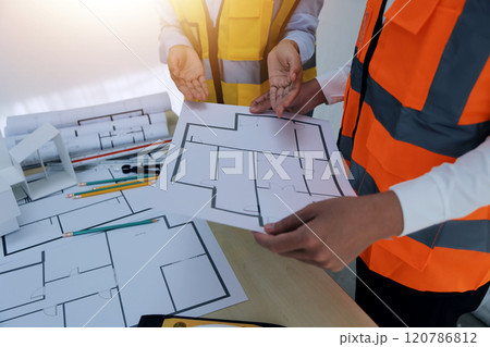 Construction and structure concept of Engineer or architect meeting for project working with partner and engineering tools on model building and blueprint in working site, contract for both companies. 120786812