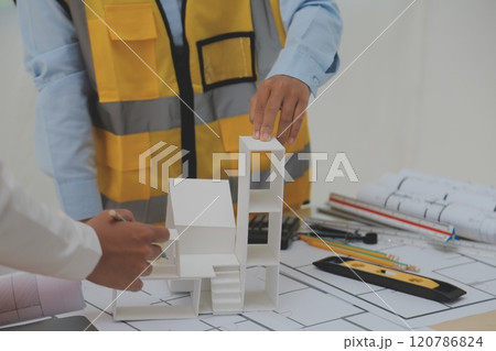 Construction and structure concept of Engineer or architect meeting for project working with partner and engineering tools on model building and blueprint in working site, contract for both companies. 120786824