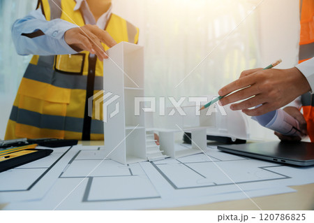 Construction and structure concept of Engineer or architect meeting for project working with partner and engineering tools on model building and blueprint in working site, contract for both companies. Construction and structure concept of Engineer or architect meeting for project working with partner and engineering tools on model building and blueprint in working site, contract for both companies. 120786825