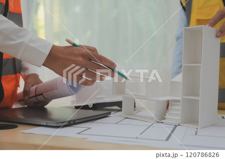 Construction and structure concept of Engineer or architect meeting for project working with partner and engineering tools on model building and blueprint in working site, contract for both companies. 120786826