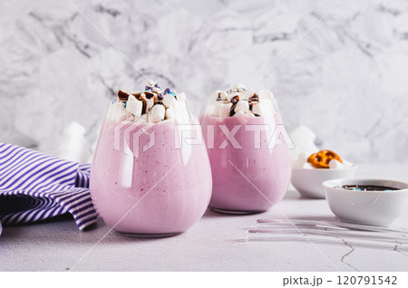 Fresh berry yogurt with marshmallows and icing in glasses on table 120791542