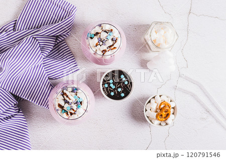 Fresh berry yogurt with marshmallows and icing in glasses on table top view 120791546