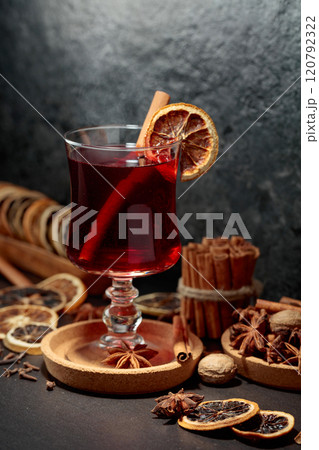 Mulled wine with ingredients and dry orange slices. 120792322