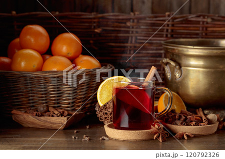 Mulled wine with ingredients on an old wooden table. Mulled wine with ingredients on an old wooden table. 120792326