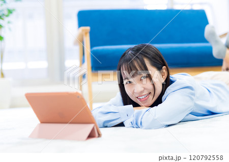 タブレットでYouTube動画を寝転んで見る若い女性 休日 リラックス 動画視聴 トリミングアップ タブレットでYouTube動画を寝転んで見る若い女性 休日 リラックス 動画視聴 トリミングアップ 120792558