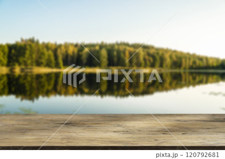 Wooden table with forest lake and nature background. Product display background. Wooden table with forest lake and nature background. Product display background. 120792681