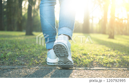 Walking in gray running shoes, back to camera 120792995