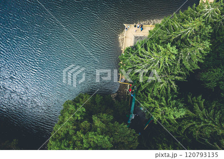 Synevir Lake with pine trees and tourists 120793135