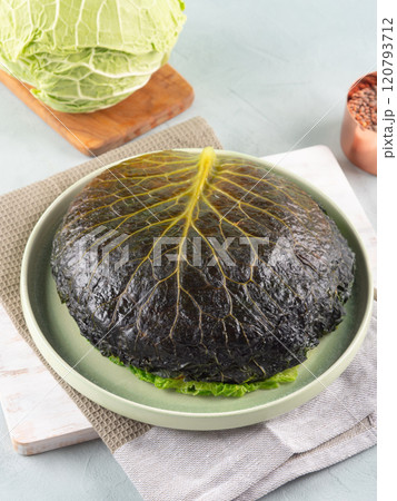 Chou farci, stuffed savoy cabbage pie with lentil quinoa ragu 120793712