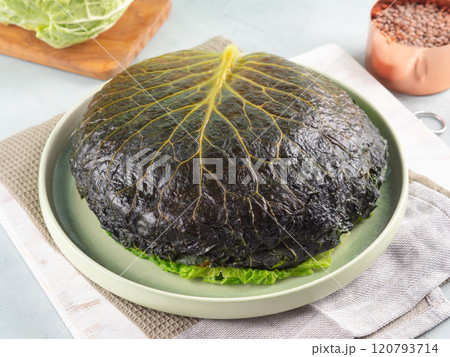 Chou farci, stuffed savoy cabbage pie with lentil quinoa ragu 120793714