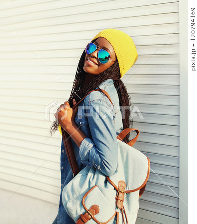 Fashion pretty young african woman walking in city Fashion pretty young african woman walking in city 120794169