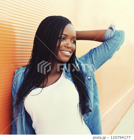 Portrait beautiful happy smiling african woman in city, profile view Portrait beautiful happy smiling african woman in city, profile view 120794177