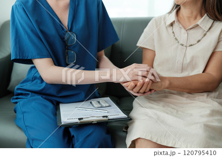 A woman in a white dress is being comforted by a woman in a blue uniform 120795410