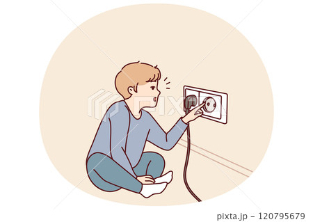 Small boy sticks fingers into socket, playing with electrical equipment and risking electric shock Small boy sticks fingers into socket, playing with electrical equipment and risking electric shock 120795679