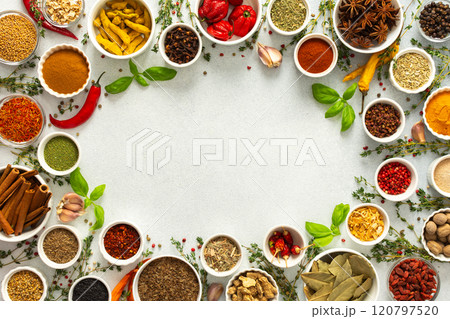 Fresh and colorful spices and herbs arranged in a frame on a gray background, adding natural beauty and culinary charm, top view and copy space 120797520