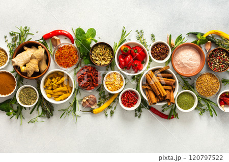 A collection of various spices and herbs on a gray background, perfect for enhancing dishes with rich flavors and textures A collection of various spices and herbs on a gray background, perfect for enhancing dishes with rich flavors and textures 120797522