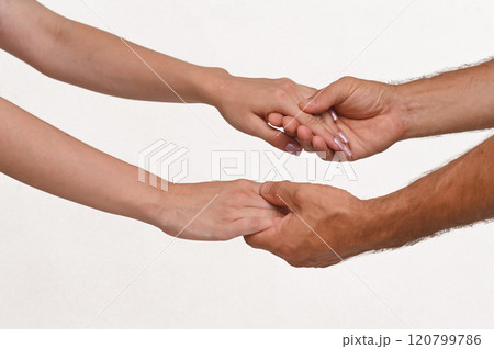 female hands in male hands on a white background close-up. isolate female hands in male hands on a white background close-up. isolate 120799786