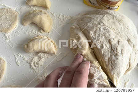 Traditional Ukrainian dish, Homemade Dumpling Preparation With Freshly Kneaded Dough Traditional Ukrainian dish, Homemade Dumpling Preparation With Freshly Kneaded Dough 120799957