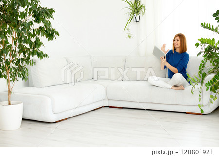 girl talking on the phone. Smiling real woman at home. White interior, copy space 120801921