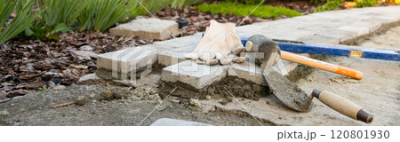 Banner, Laying paving stones on cement mortar. Laying a garden path made of tiles. Self-laying of concrete paving slabs in the courtyard of the house. do it yourself. DIY 120801930