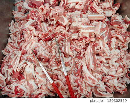 Freshly Cut Pork Belly Pieces in a Large Metal Container 120802359